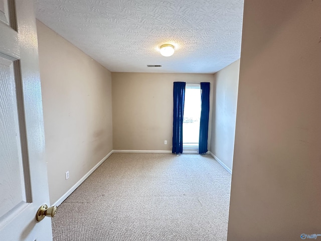 203 Lincoln Ave, Muscle Shoals, AL 35661 - empty room with a textured ceiling, carpet floors, and baseboards