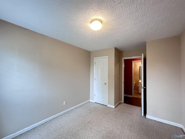 203 Lincoln Ave, Muscle Shoals, AL 35661 - unfurnished bedroom with carpet, baseboards, and a textured ceiling