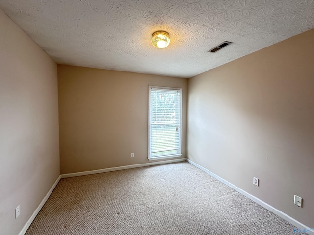203 Lincoln Ave, Muscle Shoals, AL 35661 - carpeted spare room featuring baseboards and a textured ceiling