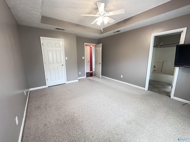 203 Lincoln Ave, Muscle Shoals, AL 35661 - unfurnished bedroom featuring carpet floors, baseboards, a raised ceiling, and a textured ceiling