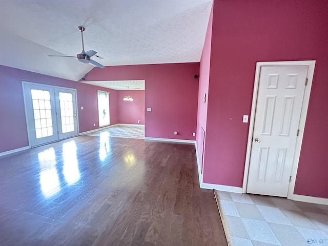 203 Lincoln Ave, Muscle Shoals, AL 35661 - unfurnished living room featuring ceiling fan, lofted ceiling, baseboards, wood finished floors, and a textured ceiling