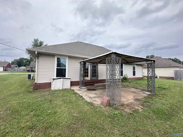 203 Lincoln Ave, Muscle Shoals, AL 35661 - back of house featuring a gazebo, a patio area, a yard, and a shingled roof
