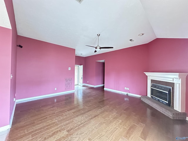 203 Lincoln Ave, Muscle Shoals, AL 35661 - unfurnished living room featuring wood finished floors, baseboards, a fireplace, a ceiling fan, and vaulted ceiling