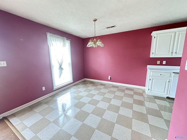 203 Lincoln Ave, Muscle Shoals, AL 35661 - unfurnished dining area with baseboards, a chandelier, and a textured ceiling
