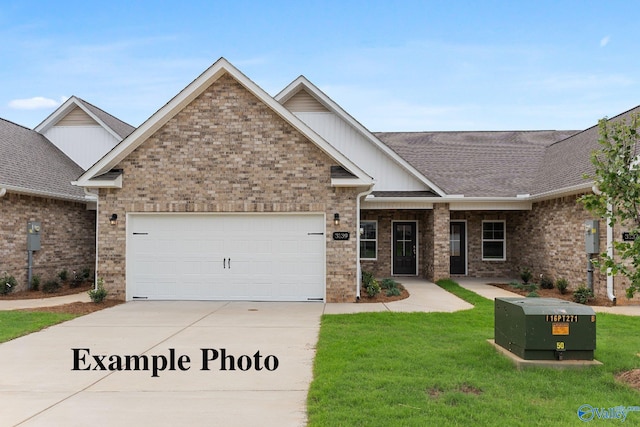 3138 Mead Way SE, Decatur, AL 35603 - view of front of home with a front yard, driveway, board and batten siding, and an attached garage