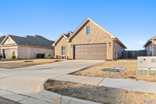 traditional home with brick siding, board and batten siding, fence, concrete driveway, and a garage