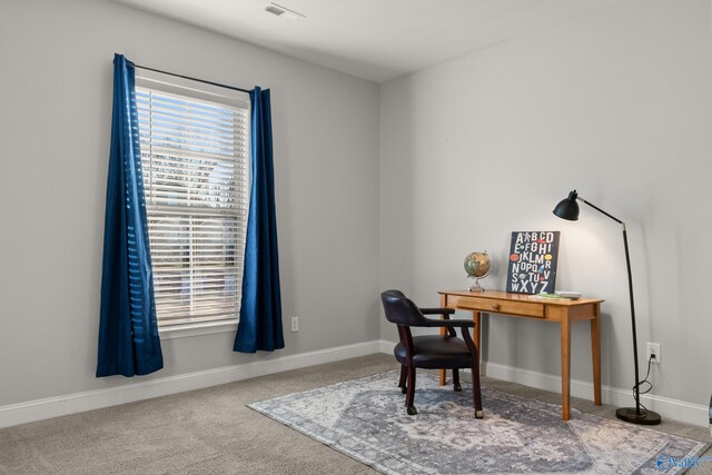 carpeted home office featuring visible vents and baseboards