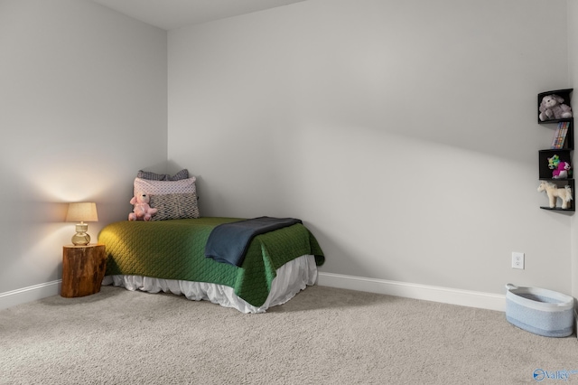 carpeted bedroom featuring baseboards