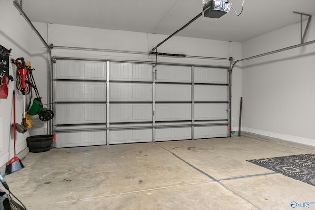 garage with a garage door opener and baseboards