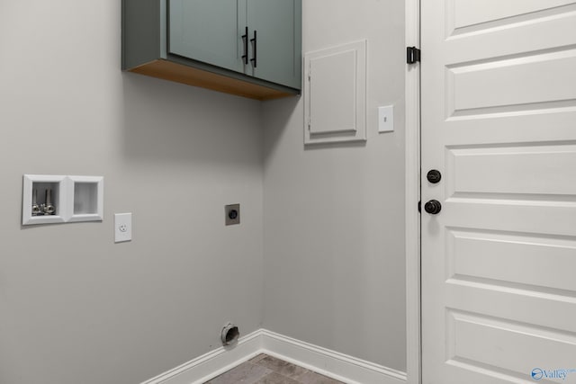 clothes washing area featuring cabinet space, hookup for an electric dryer, hookup for a washing machine, and baseboards