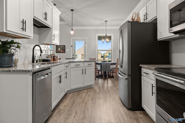 kitchen featuring a sink, light wood-type flooring, appliances with stainless steel finishes, and white cabinetry