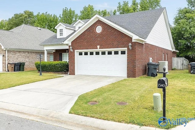 view of front of property with a garage, cooling unit, and a front lawn