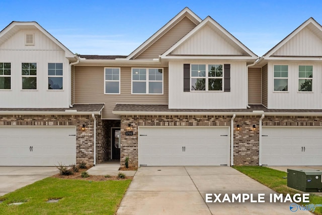 1716 Stampede Cir, Huntsville, AL 35803 - view of property featuring an attached garage, brick siding, driveway, and roof with shingles