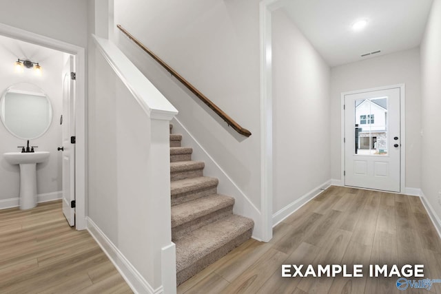 entryway featuring sink and light hardwood / wood-style flooring