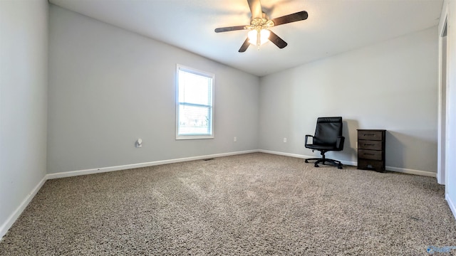 unfurnished office featuring carpet, baseboards, and ceiling fan