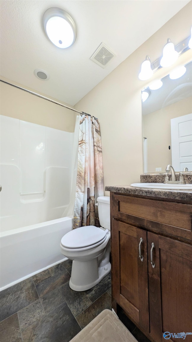 bathroom with visible vents, stone finish flooring, toilet, shower / bath combo with shower curtain, and vanity