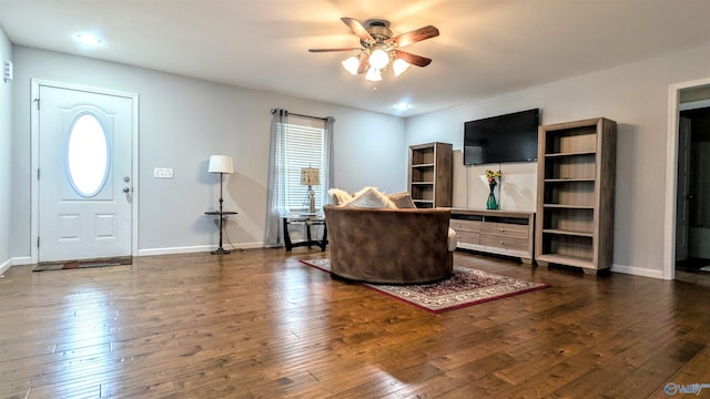 living room with baseboards, a ceiling fan, and wood-type flooring