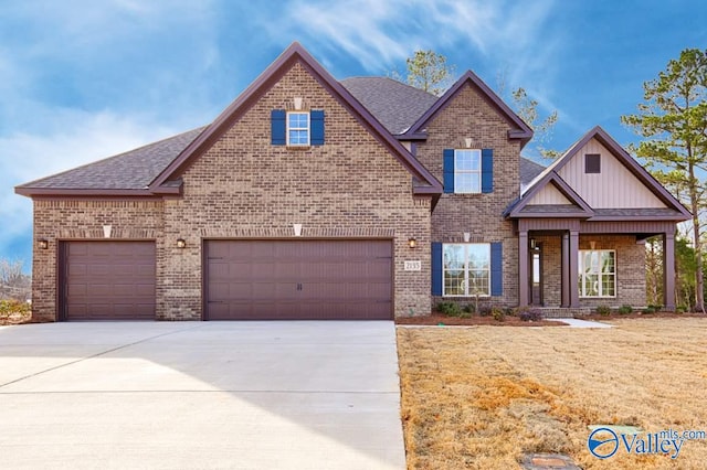 craftsman house with a front yard and a garage