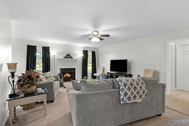 14249 Parker Rd, Athens, AL 35611 - living area with light carpet, a ceiling fan, plenty of natural light, a lit fireplace, and a textured ceiling