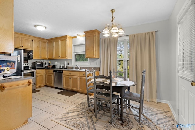 14249 Parker Rd, Athens, AL 35611 - kitchen featuring appliances with stainless steel finishes, a sink, a chandelier, light tile patterned floors, and dark countertops