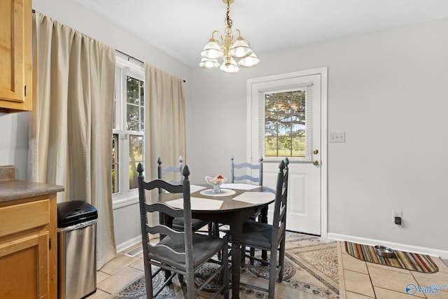 14249 Parker Rd, Athens, AL 35611 - dining space featuring healthy amount of natural light, a chandelier, light tile patterned flooring, and baseboards