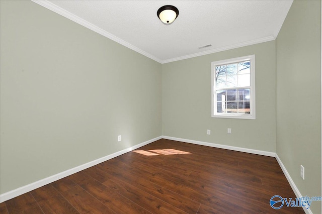 empty room featuring crown molding, dark hardwood / wood-style floors, and a textured ceiling