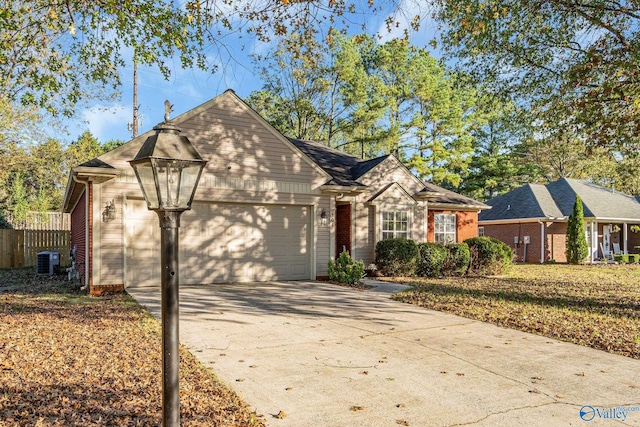 ranch-style home featuring a front lawn, central AC unit, and a garage