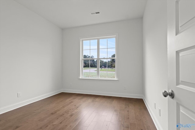 empty room with dark hardwood / wood-style floors