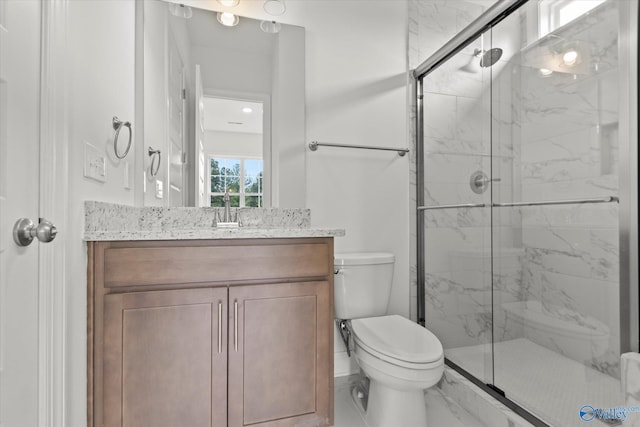 bathroom featuring walk in shower, vanity, and toilet