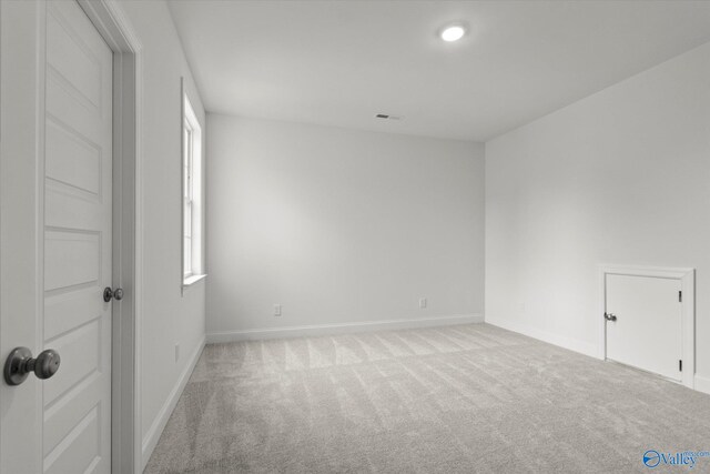 spare room with light carpet