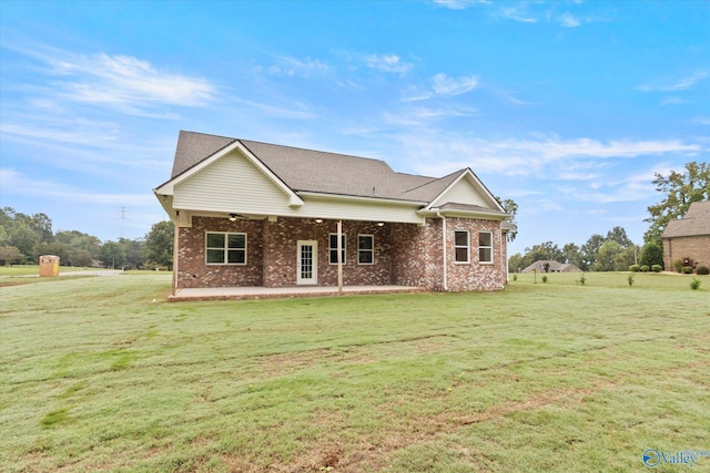 back of property with a patio area and a lawn