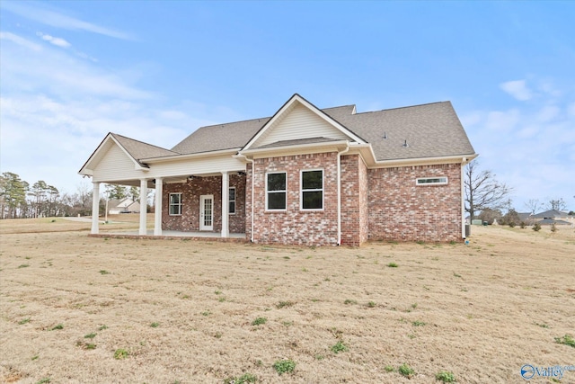 view of front facade with a front yard and a patio area