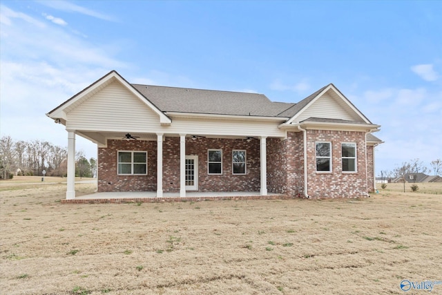 view of front of property with a front lawn, a patio, and ceiling fan