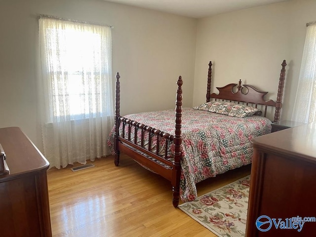 bedroom featuring visible vents and light wood-style floors