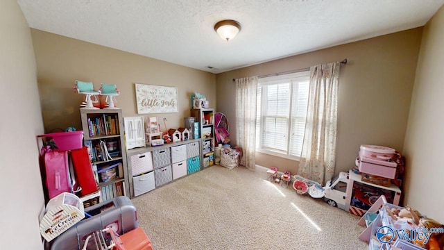 rec room with a textured ceiling and carpet floors