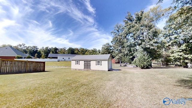 view of front of property with an outdoor structure and a front lawn