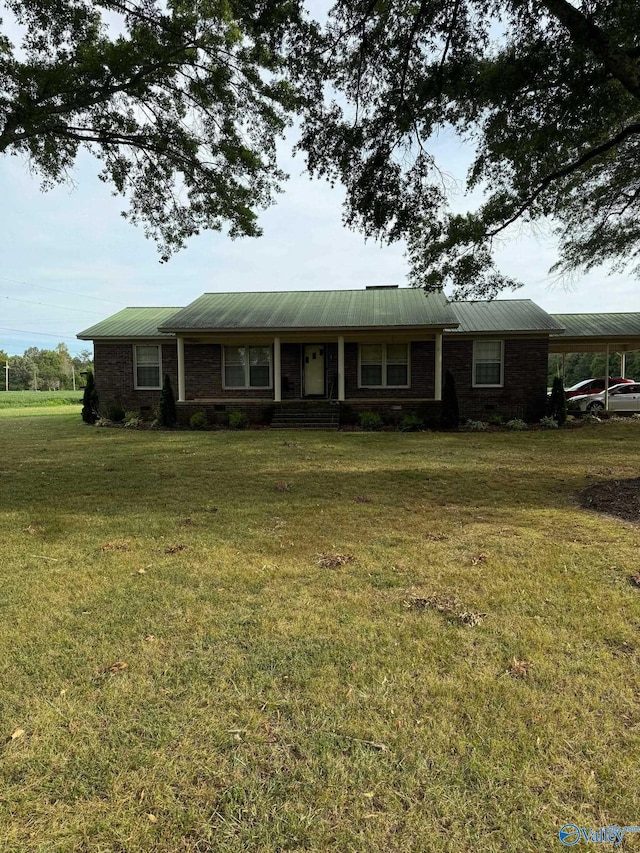 view of front facade featuring a front yard and a carport