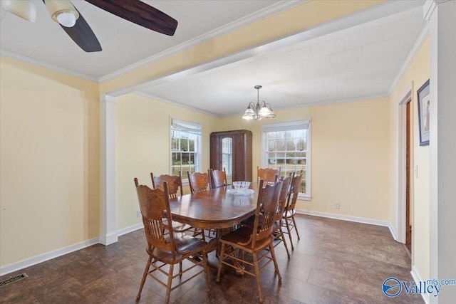 dining room featuring ceiling fan with notable chandelier, a wealth of natural light, and ornamental molding