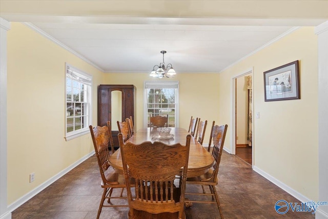 dining space featuring crown molding, plenty of natural light, and a notable chandelier