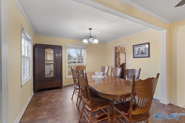 dining space featuring crown molding and a chandelier