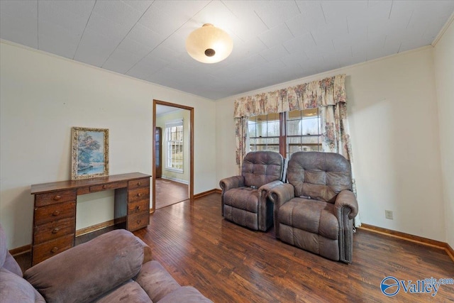 living room with dark wood-type flooring and ornamental molding