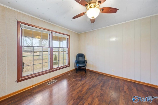 unfurnished room with crown molding, dark hardwood / wood-style floors, and ceiling fan