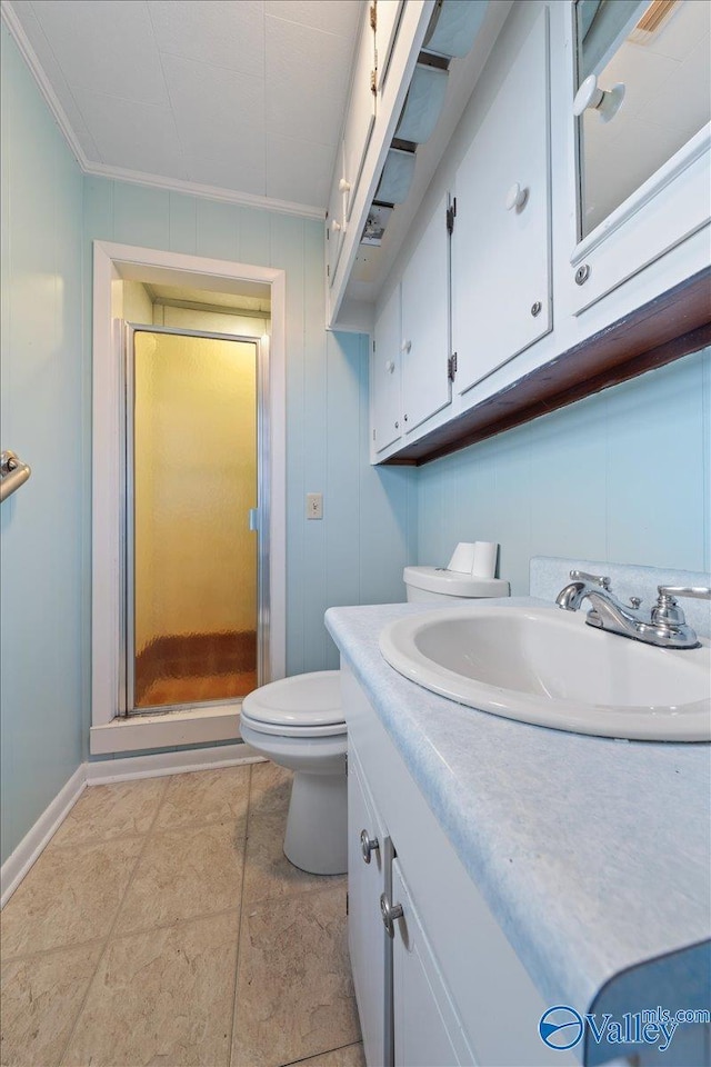 bathroom featuring vanity, an enclosed shower, crown molding, and toilet