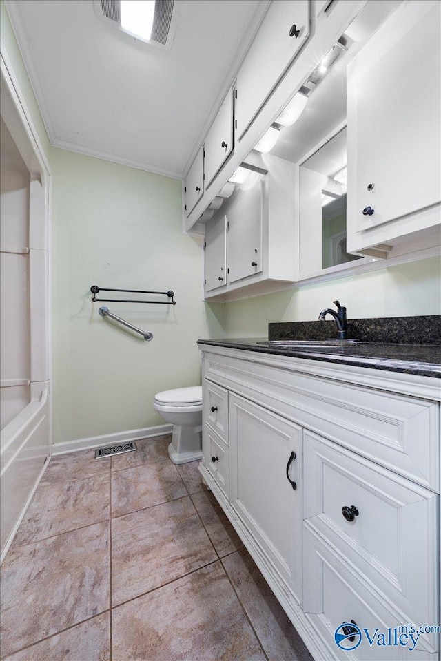 bathroom with vanity, ornamental molding, and toilet