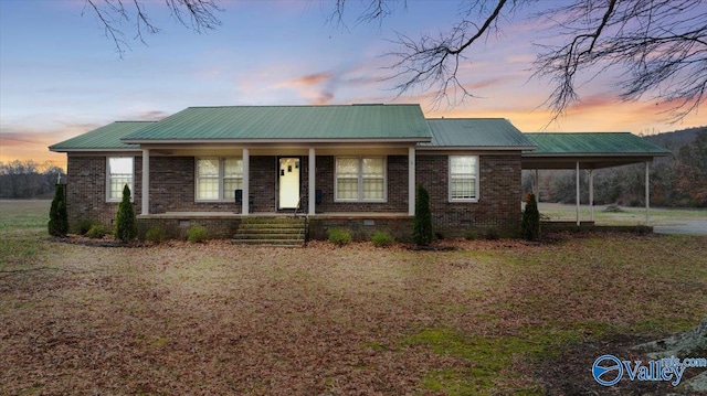 ranch-style house with a carport and a porch