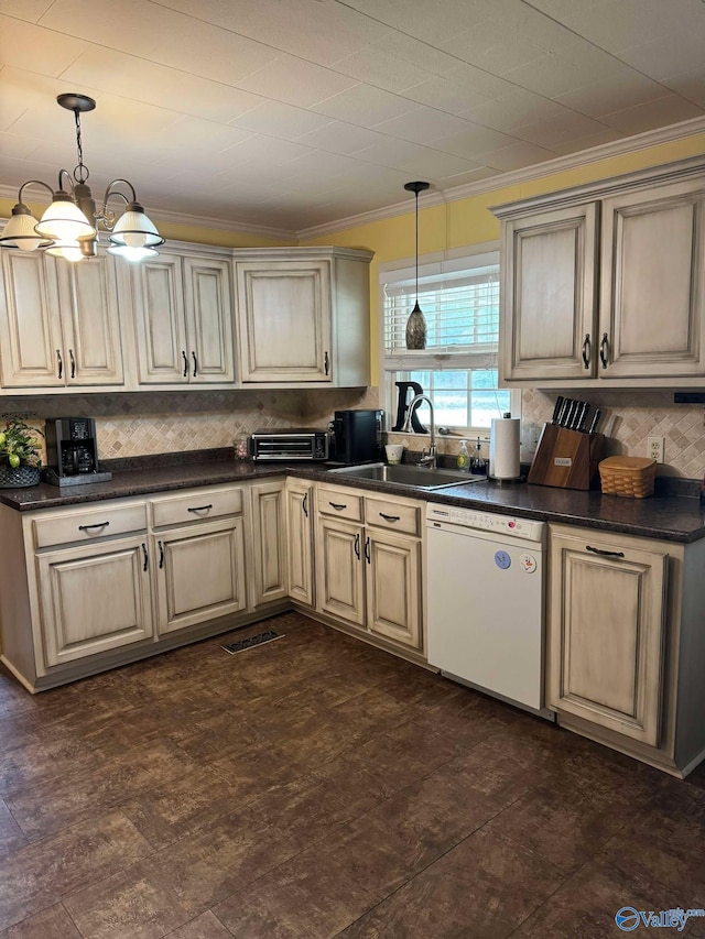 kitchen with dishwasher, sink, pendant lighting, and cream cabinetry