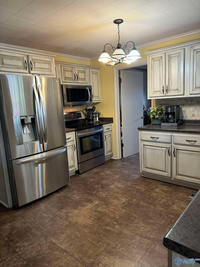 kitchen featuring crown molding, stainless steel appliances, decorative light fixtures, and cream cabinets