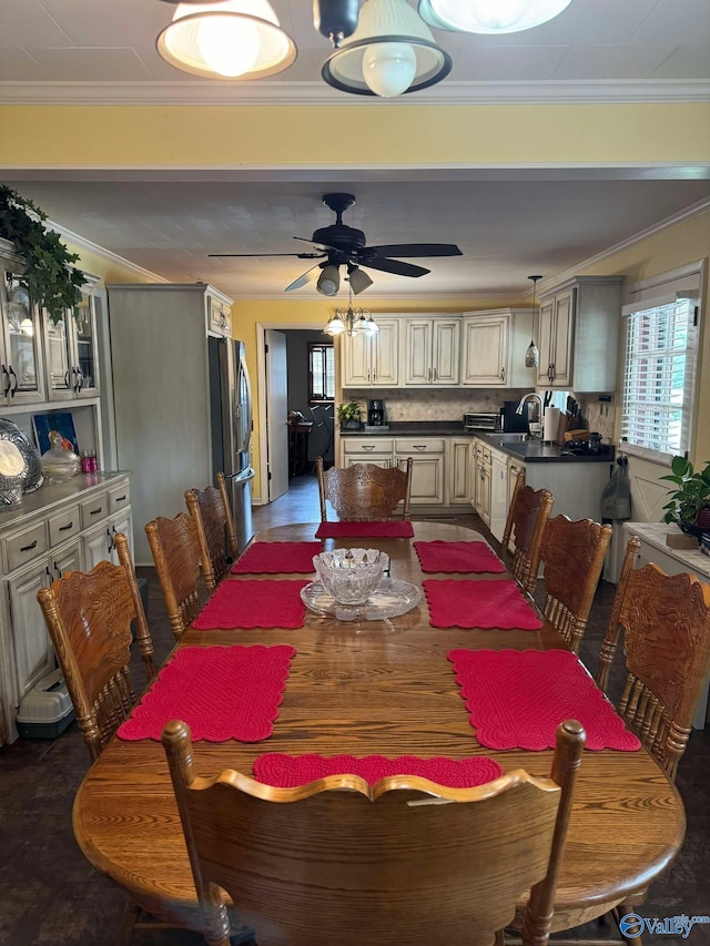 dining room with crown molding, plenty of natural light, and ceiling fan