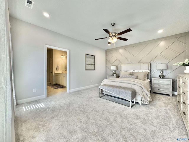 bedroom with light carpet, ceiling fan, and ensuite bathroom