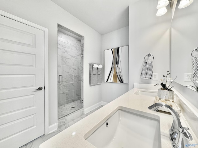 bathroom featuring a shower with door and vanity